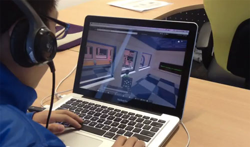 Photo from one of our product testing sessions where a young boy wearing headphones is playing a 3D game on a laptop